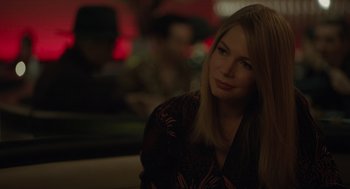 Movie still from “Venom: Let There Be Carnage” (2021), directed by Andy Serkis – A beautiful young lady sitting at a table in a restaurant; Close Up shot, Over the shoulder angle