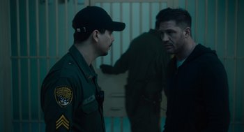 Movie still from “Venom: Let There Be Carnage” (2021), directed by Andy Serkis – Two men in uniform talking to each other; Medium shot, Over the shoulder angle