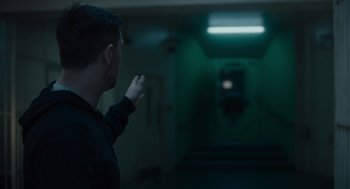 Movie still from “Venom: Let There Be Carnage” (2021), directed by Andy Serkis – A man standing in front of an exit door; Medium shot, High angle