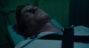 Movie still from “Venom: Let There Be Carnage” (2021), directed by Andy Serkis – A man laying on a bed with his eyes closed; Close Up shot, High angle