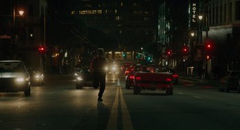 Movie still from “Venom: Let There Be Carnage” (2021), directed by Andy Serkis – A man walking down a street at night; Wide shot, Low angle