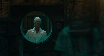 Movie still from “Venom: Let There Be Carnage” (2021), directed by Andy Serkis – An older woman is reflected in a round mirror; Medium shot, Over the shoulder angle