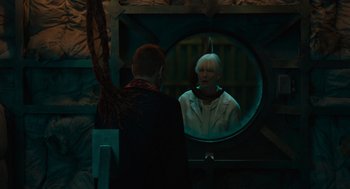 Movie still from “Venom: Let There Be Carnage” (2021), directed by Andy Serkis – A man looking in the mirror at a woman in the mirror; Medium shot, Over the shoulder angle