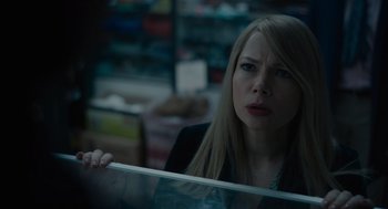 Movie still from “Venom: Let There Be Carnage” (2021), directed by Andy Serkis – A woman is looking at the camera in a store; Close Up shot, Over the shoulder angle