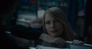 Movie still from “Venom: Let There Be Carnage” (2021), directed by Andy Serkis – A woman sitting in front of a counter with her hand on her shoulder; Close Up shot, Over the shoulder angle