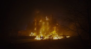 Movie still from “Venom: Let There Be Carnage” (2021), directed by Andy Serkis – A fire that is burning in the middle of the night; Extreme Wide shot, Low angle
