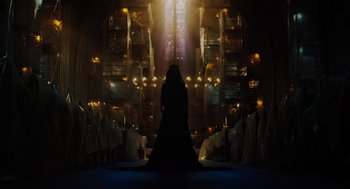 Movie still from “Venom: Let There Be Carnage” (2021), directed by Andy Serkis – A woman in a long black dress standing in front of a church; Extreme Wide shot, Low angle