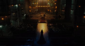 Movie still from “Venom: Let There Be Carnage” (2021), directed by Andy Serkis – A person standing in front of an altar in a church at night; Extreme Wide shot, High angle