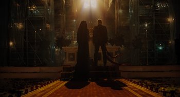 Movie still from “Venom: Let There Be Carnage” (2021), directed by Andy Serkis – A couple of people standing in front of a building; Wide shot, Low angle