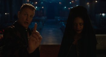 Movie still from “Venom: Let There Be Carnage” (2021), directed by Andy Serkis – A man and a woman are sitting in a dark room; Medium shot, Over the shoulder angle