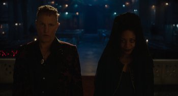 Movie still from “Venom: Let There Be Carnage” (2021), directed by Andy Serkis – A man and a woman standing next to each other in the dark; Medium shot, Low angle