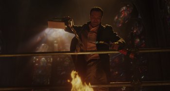 Movie still from “Venom: Let There Be Carnage” (2021), directed by Andy Serkis – A man in a boxing ring holding a sword; Medium shot, Low angle