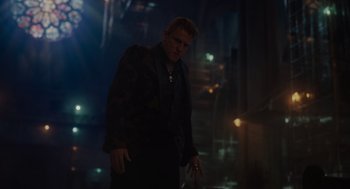 Movie still from “Venom: Let There Be Carnage” (2021), directed by Andy Serkis – A man standing in the dark with his hands in his pockets; Medium shot, Low angle