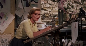 Movie still from “Vertigo” (1958), directed by Alfred Hitchcock – An older woman is painting in her studio; Medium shot, Low angle