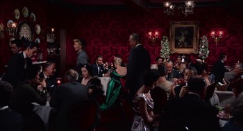 Movie still from “Vertigo” (1958), directed by Alfred Hitchcock – A group of people sitting at tables in a room; Extreme Wide shot, High angle