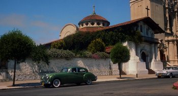 Movie still from “Vertigo” (1958), directed by Alfred Hitchcock – An old car parked on the side of the street; Extreme Wide shot, Low angle