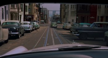 Movie still from “Vertigo” (1958), directed by Alfred Hitchcock – Cars driving down the street in a city; Wide shot, High angle