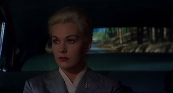 Movie still from “Vertigo” (1958), directed by Alfred Hitchcock – A woman with blonde hair sitting in the back of a car; Close Up shot, Low angle