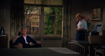 Movie still from “Vertigo” (1958), directed by Alfred Hitchcock – A man and a woman sitting in front of a window; Wide shot, High angle
