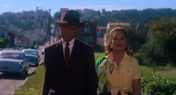 Movie still from “Vertigo” (1958), directed by Alfred Hitchcock – A man and a woman are standing in a field; Medium shot, Low angle
