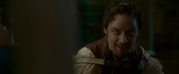 Movie still from “Victor Frankenstein” (2015), directed by Paul McGuigan – A person wearing a suit and tie; Close Up shot, Over the shoulder angle