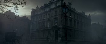 Movie still from “Victor Frankenstein” (2015), directed by Paul McGuigan – A large building with a street light in front of it; Extreme Wide shot, Low angle