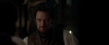 Movie still from “Victor Frankenstein” (2015), directed by Paul McGuigan – A person wearing a suit and tie; Close Up shot, Over the shoulder angle