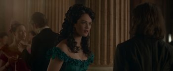 Movie still from “Victor Frankenstein” (2015), directed by Paul McGuigan – A woman in a green dress is standing in front of a window; Close Up shot, Over the shoulder angle