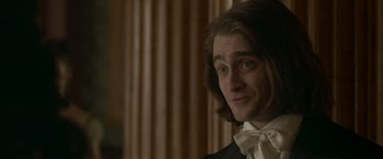 Movie still from “Victor Frankenstein” (2015), directed by Paul McGuigan – A person wearing a suit and bow tie; Close Up shot, Over the shoulder angle