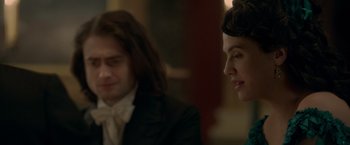 Movie still from “Victor Frankenstein” (2015), directed by Paul McGuigan – A man and a woman sitting next to each other in a room; Close Up shot, Over the shoulder angle