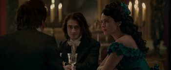 Movie still from “Victor Frankenstein” (2015), directed by Paul McGuigan – A man and a woman sitting next to each other; Medium shot, Over the shoulder angle