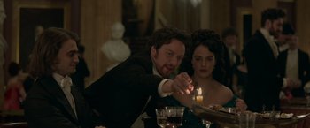 Movie still from “Victor Frankenstein” (2015), directed by Paul McGuigan – A man and a woman sitting at a dinner table; Medium shot, Over the shoulder angle