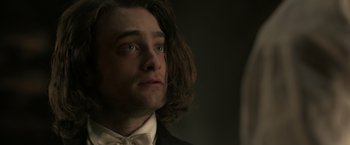 Movie still from “Victor Frankenstein” (2015), directed by Paul McGuigan – A person wearing a suit and bow tie; Close Up shot, Over the shoulder angle
