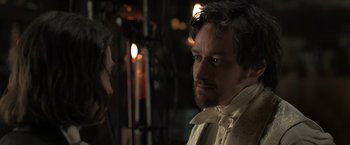 Movie still from “Victor Frankenstein” (2015), directed by Paul McGuigan – A person wearing a suit and tie; Close Up shot, Over the shoulder angle