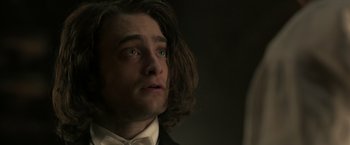 Movie still from “Victor Frankenstein” (2015), directed by Paul McGuigan – A person with long hair; Close Up shot, Over the shoulder angle