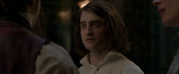 Movie still from “Victor Frankenstein” (2015), directed by Paul McGuigan – A person with long brown hair; Close Up shot, Over the shoulder angle