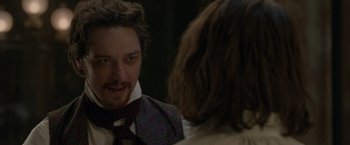 Movie still from “Victor Frankenstein” (2015), directed by Paul McGuigan – A man wearing a neck tie looking at a woman in the mirror; Close Up shot, Over the shoulder angle