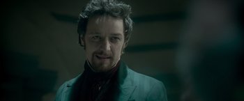 Movie still from “Victor Frankenstein” (2015), directed by Paul McGuigan – A person wearing a suit and tie; Close Up shot, Over the shoulder angle
