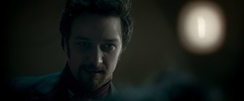 Movie still from “Victor Frankenstein” (2015), directed by Paul McGuigan – A person wearing a suit and tie; Close Up shot, Over the shoulder angle