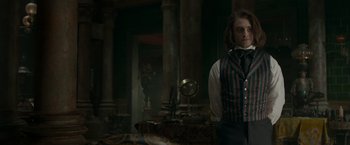 Movie still from “Victor Frankenstein” (2015), directed by Paul McGuigan – A man standing in front of a table with a mirror; Medium shot, Over the shoulder angle
