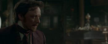 Movie still from “Victor Frankenstein” (2015), directed by Paul McGuigan – A person wearing a suit and tie; Close Up shot, Over the shoulder angle