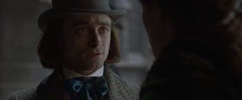 Movie still from “Victor Frankenstein” (2015), directed by Paul McGuigan – A person wearing a hat and a tie; Close Up shot, Over the shoulder angle