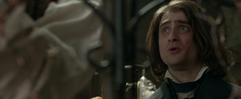 Movie still from “Victor Frankenstein” (2015), directed by Paul McGuigan – A person with long hair; Close Up shot, Over the shoulder angle