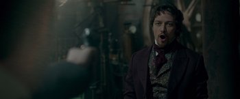Movie still from “Victor Frankenstein” (2015), directed by Paul McGuigan – A man wearing a suit and a red tie; Close Up shot, Over the shoulder angle