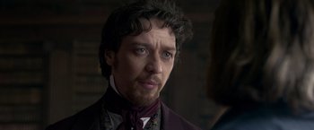 Movie still from “Victor Frankenstein” (2015), directed by Paul McGuigan – A person wearing a suit and tie; Close Up shot, Over the shoulder angle