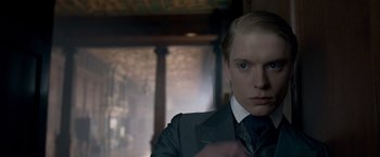 Movie still from “Victor Frankenstein” (2015), directed by Paul McGuigan – A man in a suit and tie looking at the camera; Close Up shot, Over the shoulder angle
