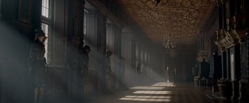 Movie still from “Victor Frankenstein” (2015), directed by Paul McGuigan – A group of people standing in a room with smoke coming out of the windows; Extreme Wide shot, Low angle