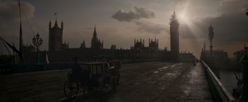 Movie still from “Victor Frankenstein” (2015), directed by Paul McGuigan – A horse drawn carriage rides down the street in front of big ben in london; Extreme Wide shot, High angle