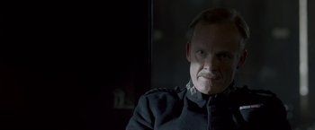 Movie still from “Victor Frankenstein” (2015), directed by Paul McGuigan – A person wearing a uniform; Close Up shot, Over the shoulder angle