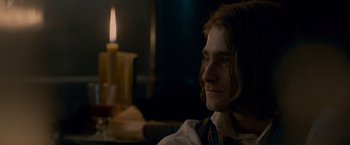 Movie still from “Victor Frankenstein” (2015), directed by Paul McGuigan – A man sitting in front of a lit candle; Close Up shot, Over the shoulder angle